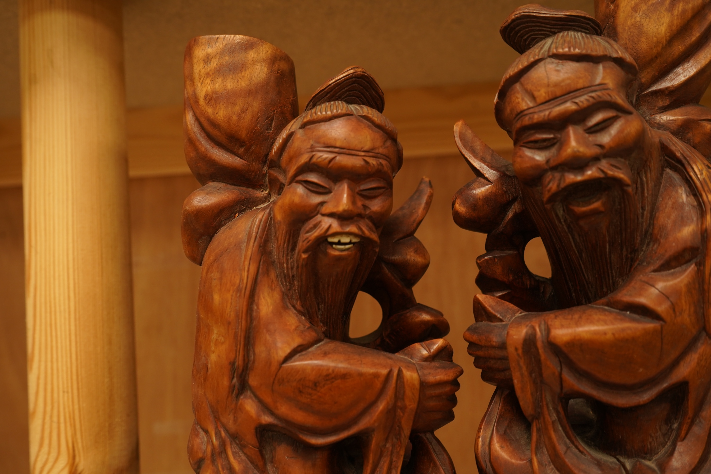 A pair of 20th century Chinese carved wood figures of sages, 31cm